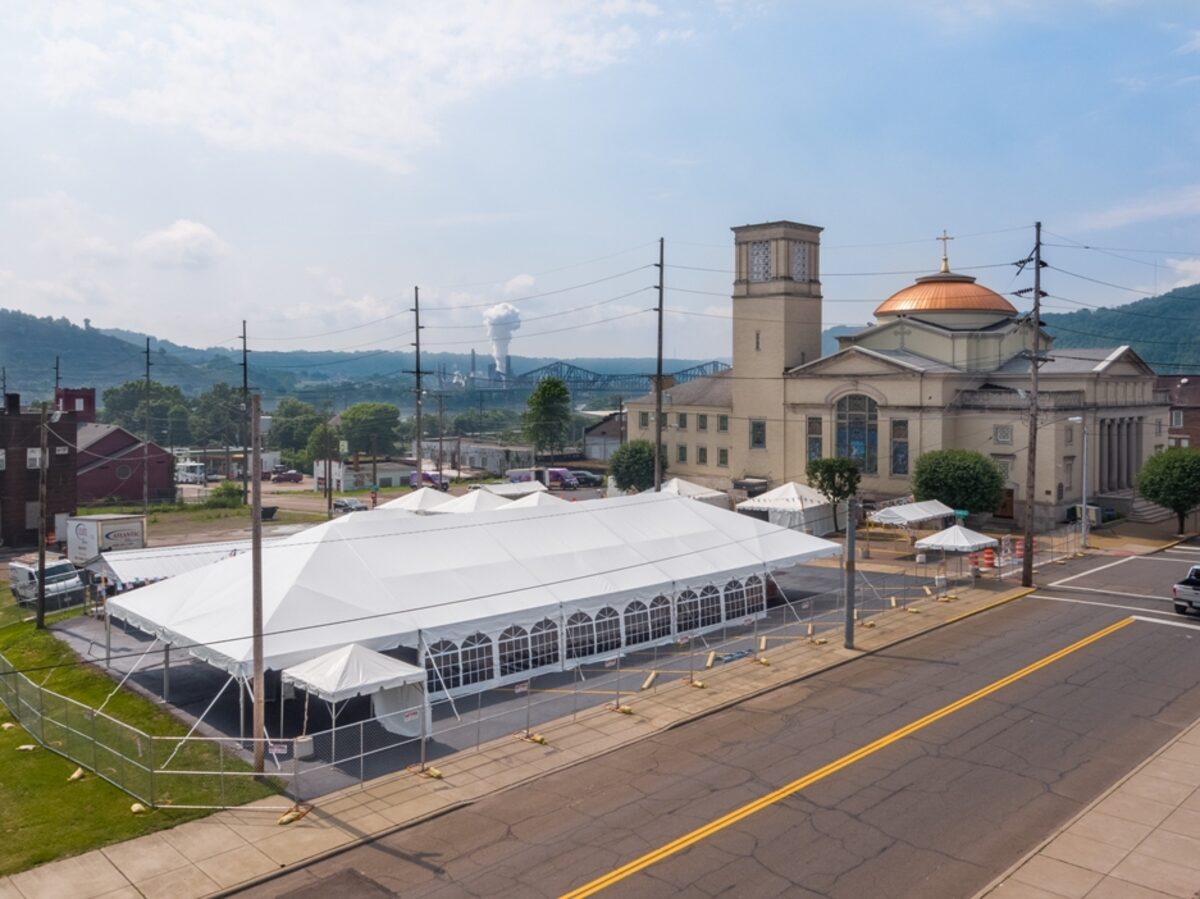 40x100 Navigator frame tent in front of a historic Steubenville cathedral with the Ohio River hills in the background