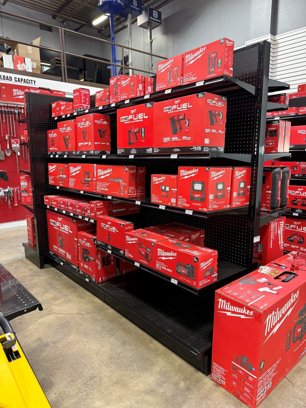 Aisle of M18 Fuel kits, nailers, and lighting on the Milwaukee shelves at General Rental in Steubenville, Ohio