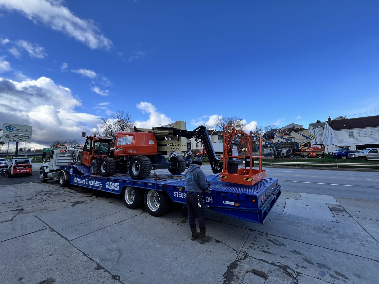 SkyTrak forklift loading a boom lift onto a trailer at General Rental's Steubenville yard