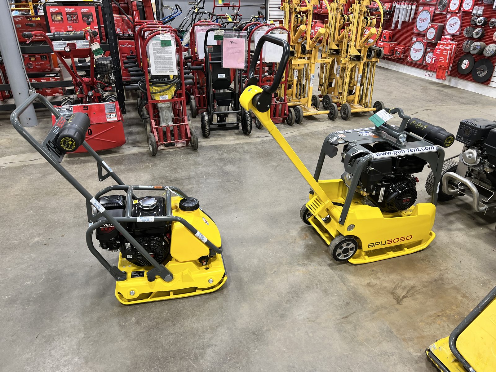 Yellow Wacker Neuson BPU3050 reversible plate compactor and single-direction plate at General Rental's Steubenville shop